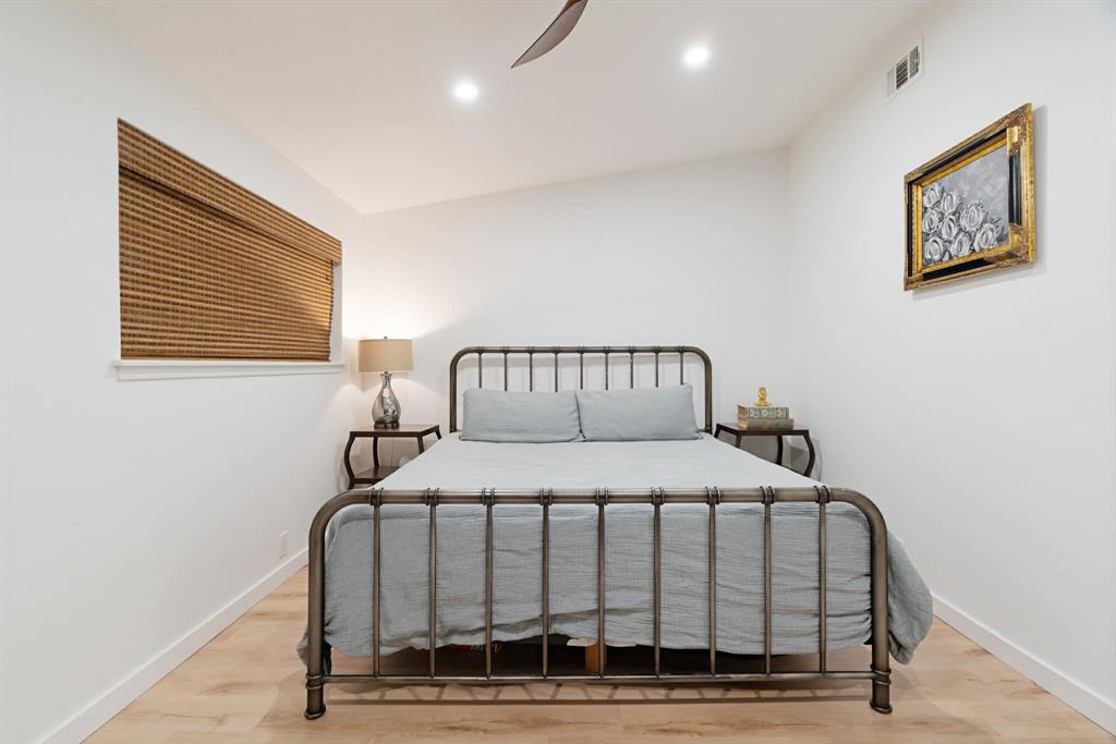 3350 Robin Road Paris, TX 75460 - Photo 11 of 21 a bedroom with a bed and wooden floor