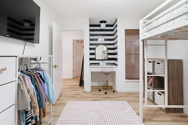 a bathroom with a sink and mirror with toilet