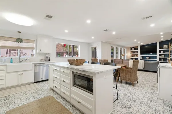 a kitchen with cabinets and chairs