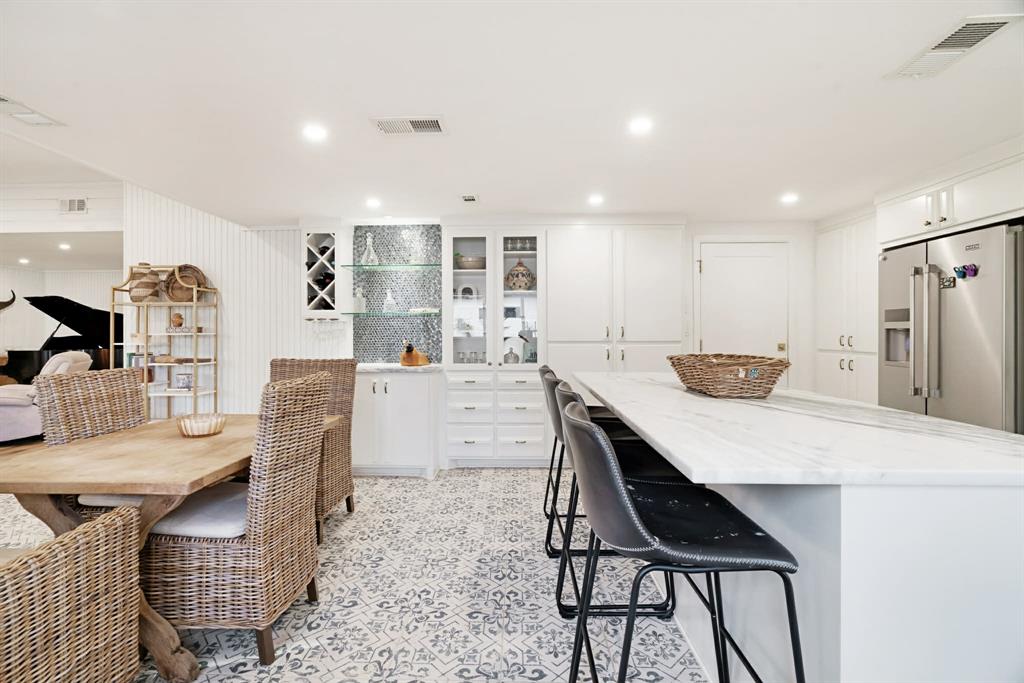 3350 Robin Road Paris, TX 75460 - Photo 5 of 21 a kitchen with stainless steel appliances kitchen island granite countertop a table chairs and a refrigerator