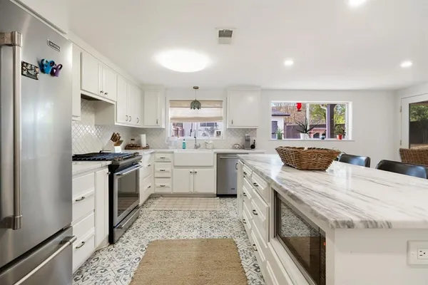 a kitchen with a sink stove and refrigerator