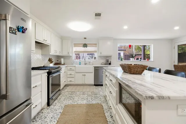 a kitchen with a sink stove and refrigerator