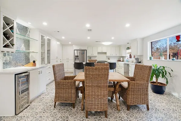 a dining room with furniture and potted plant