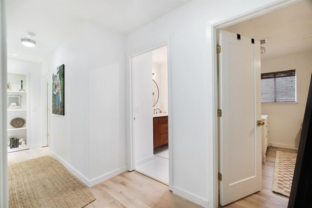 3350 Robin Road Paris, TX 75460 - Photo 10 of 21 a view of a hallway with bathroom and wooden floor