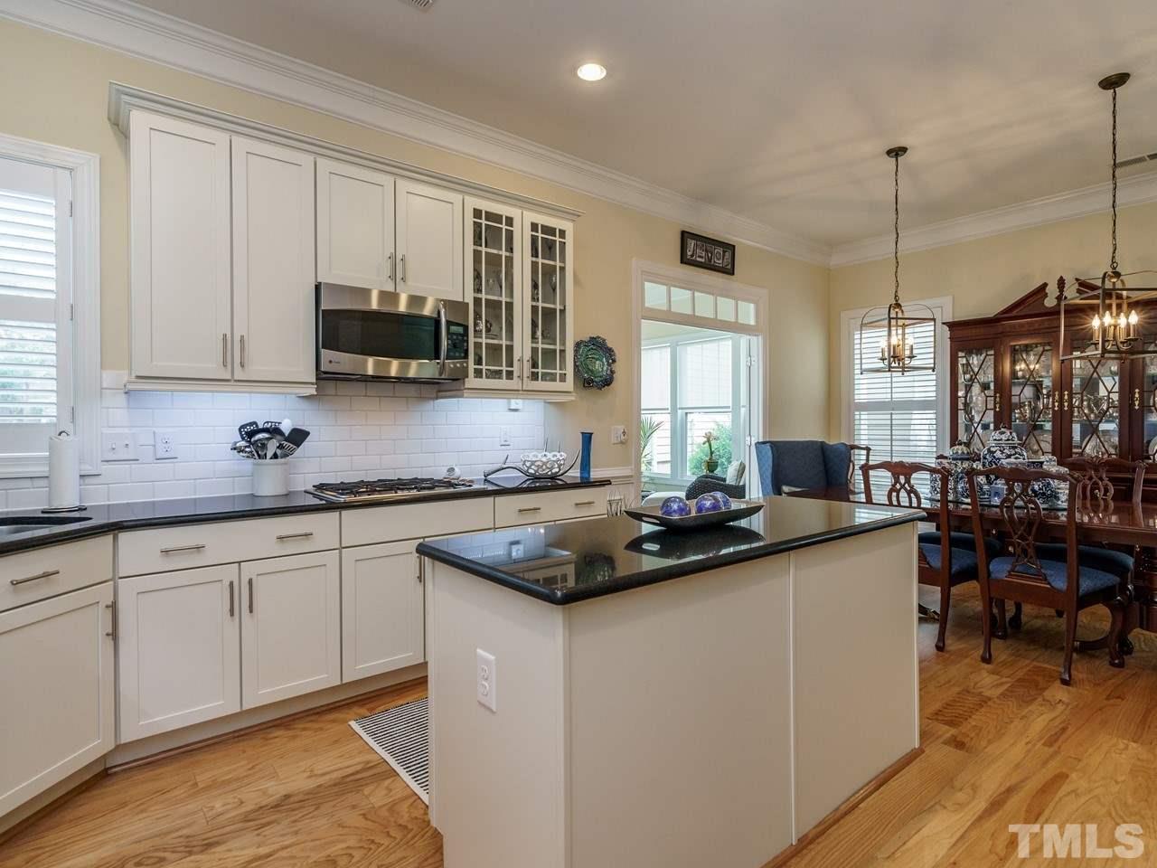 5610 Wade Park Boulevard Raleigh, NC 27607 - Photo 14 of 30 a kitchen with stainless steel appliances granite countertop a sink stove and cabinets