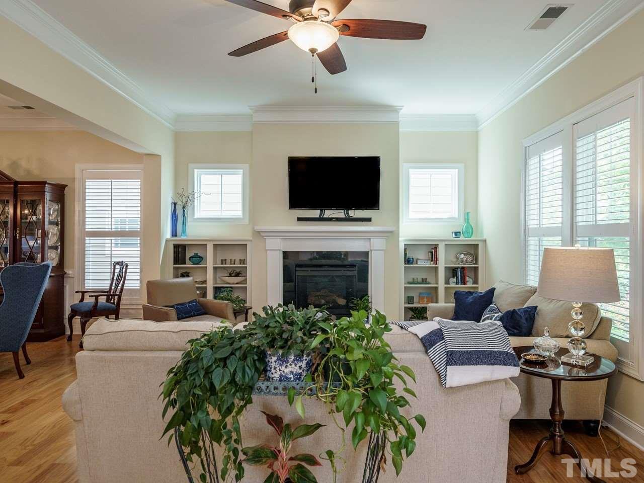 5610 Wade Park Boulevard Raleigh, NC 27607 - Photo 5 of 30 a living room with furniture fireplace and a flat screen tv