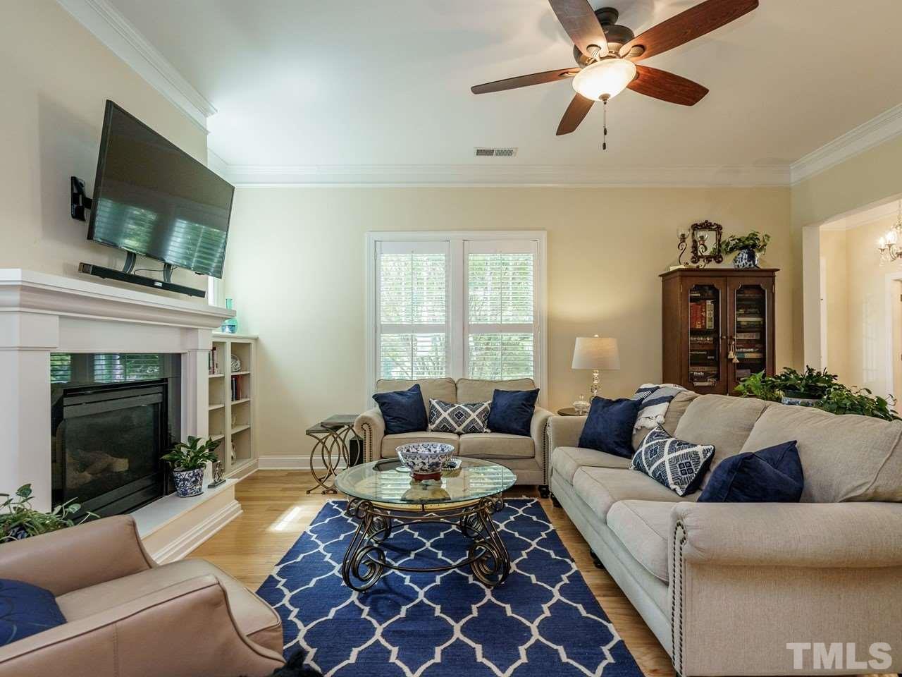 5610 Wade Park Boulevard Raleigh, NC 27607 - Photo 7 of 30 a living room with furniture a fireplace and a flat screen tv