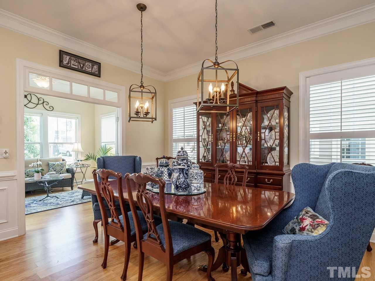 5610 Wade Park Boulevard Raleigh, NC 27607 - Photo 9 of 30 a view of a dining room with furniture window and wooden floor