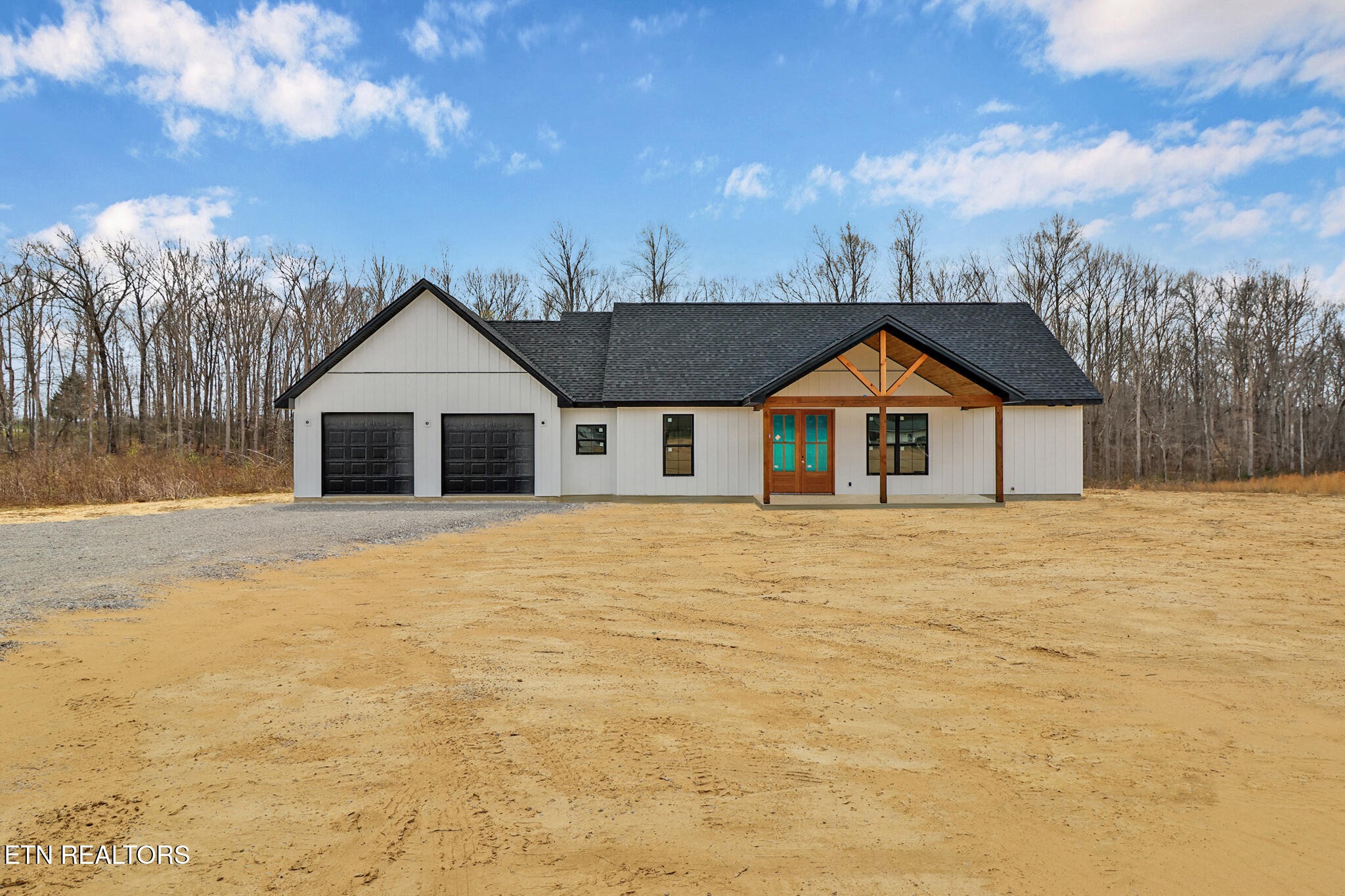 1468 Taylor Place Road Jamestown, TN 38556 - Photo 2 of 27 a front view of a house with a yard and garage