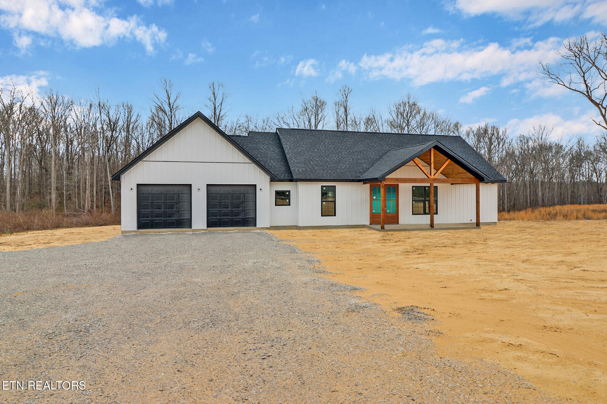 1468 Taylor Place Road Jamestown, TN 38556 - Photo 4 of 27 a front view of a house with a yard and garage