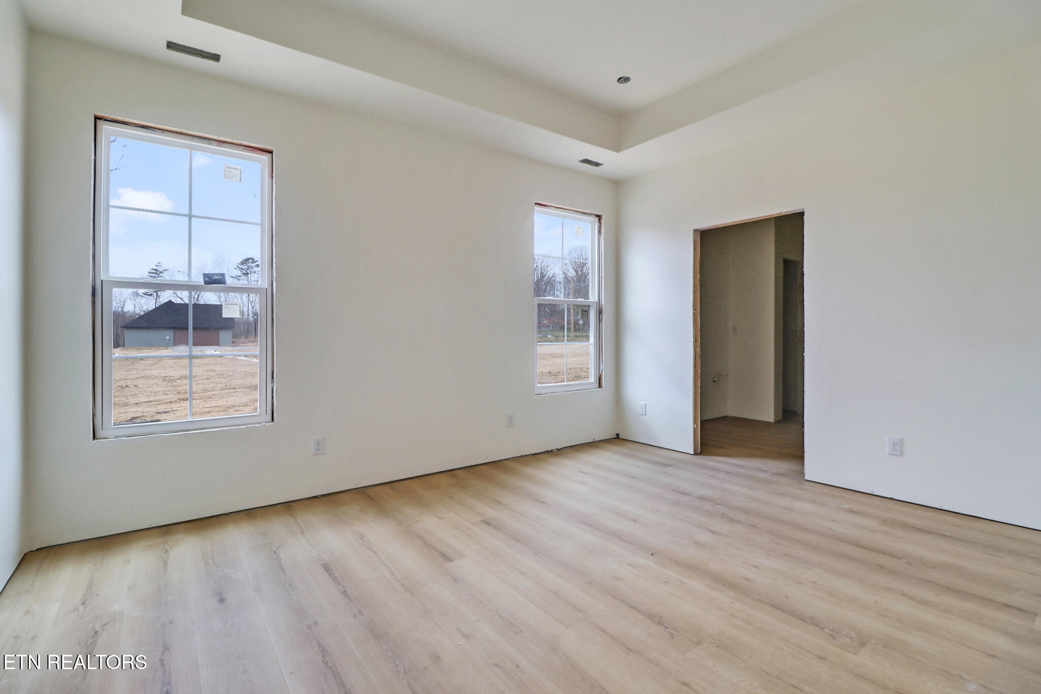 1468 Taylor Place Road Jamestown, TN 38556 - Photo 10 of 27 an empty room with wooden floor and windows