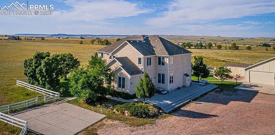 an aerial view of a house with a garden and lake view