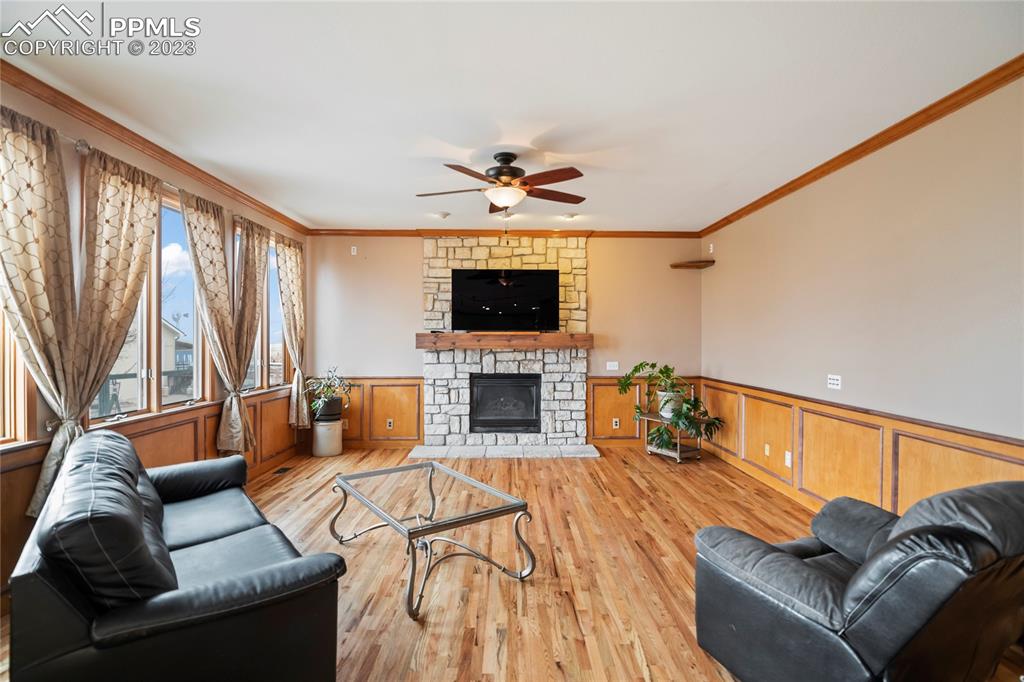 20880 Scott Road Calhan, CO 80808 - Photo 15 of 39 a living room with furniture a fireplace and a flat screen tv