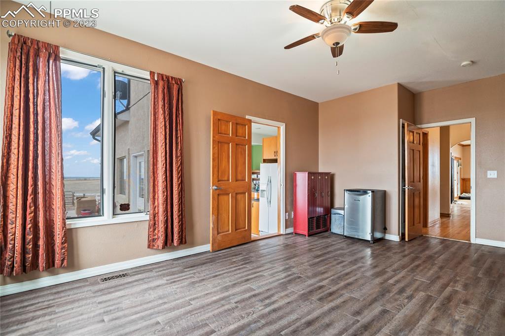 20880 Scott Road Calhan, CO 80808 - Photo 20 of 39 a view of a livingroom with wooden floor and a ceiling fan