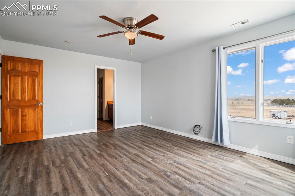 20880 Scott Road Calhan, CO 80808 - Photo 28 of 39 wooden floor in an empty room with a window