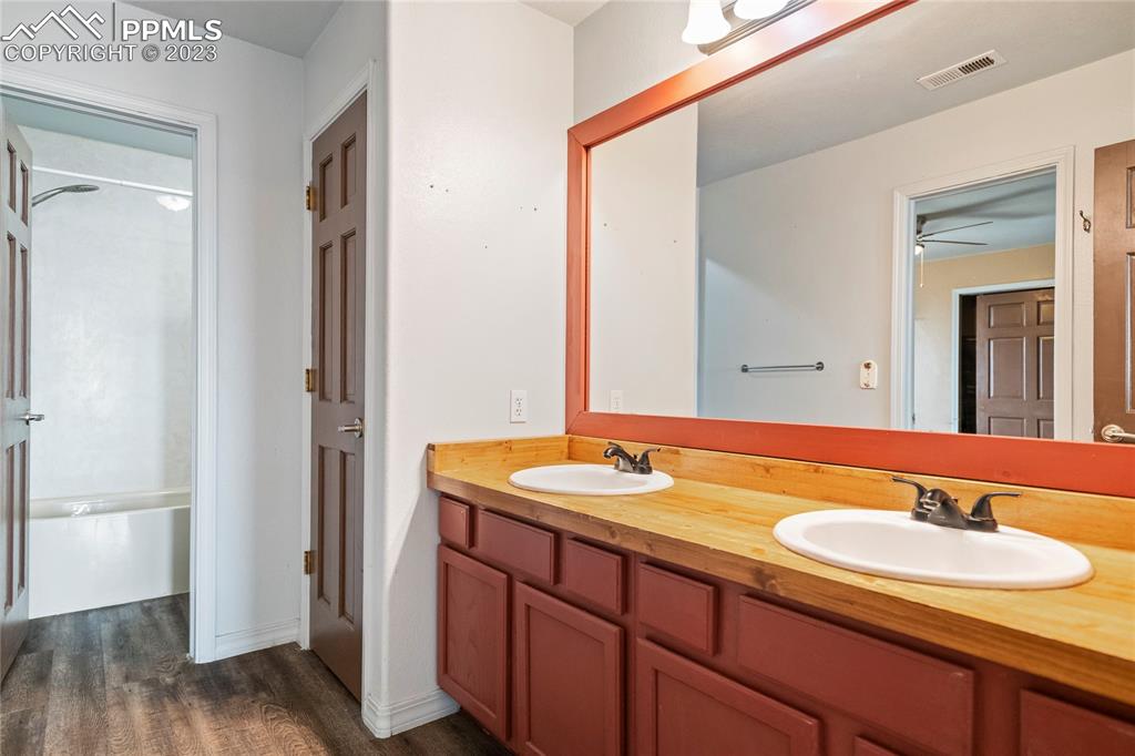 20880 Scott Road Calhan, CO 80808 - Photo 29 of 39 a bathroom with a granite countertop sink and a mirror