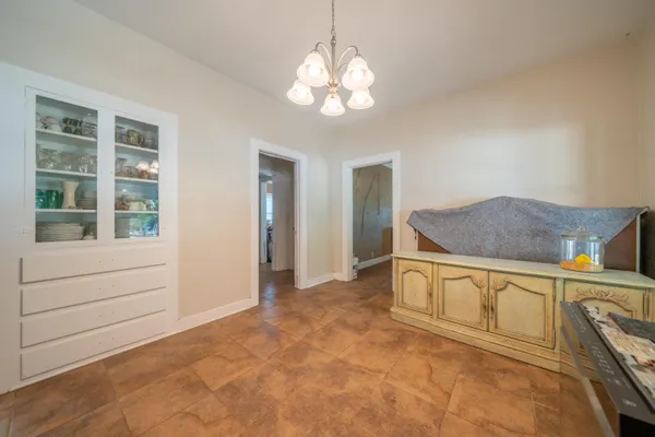 a view of kitchen with granite countertop cabinets and window