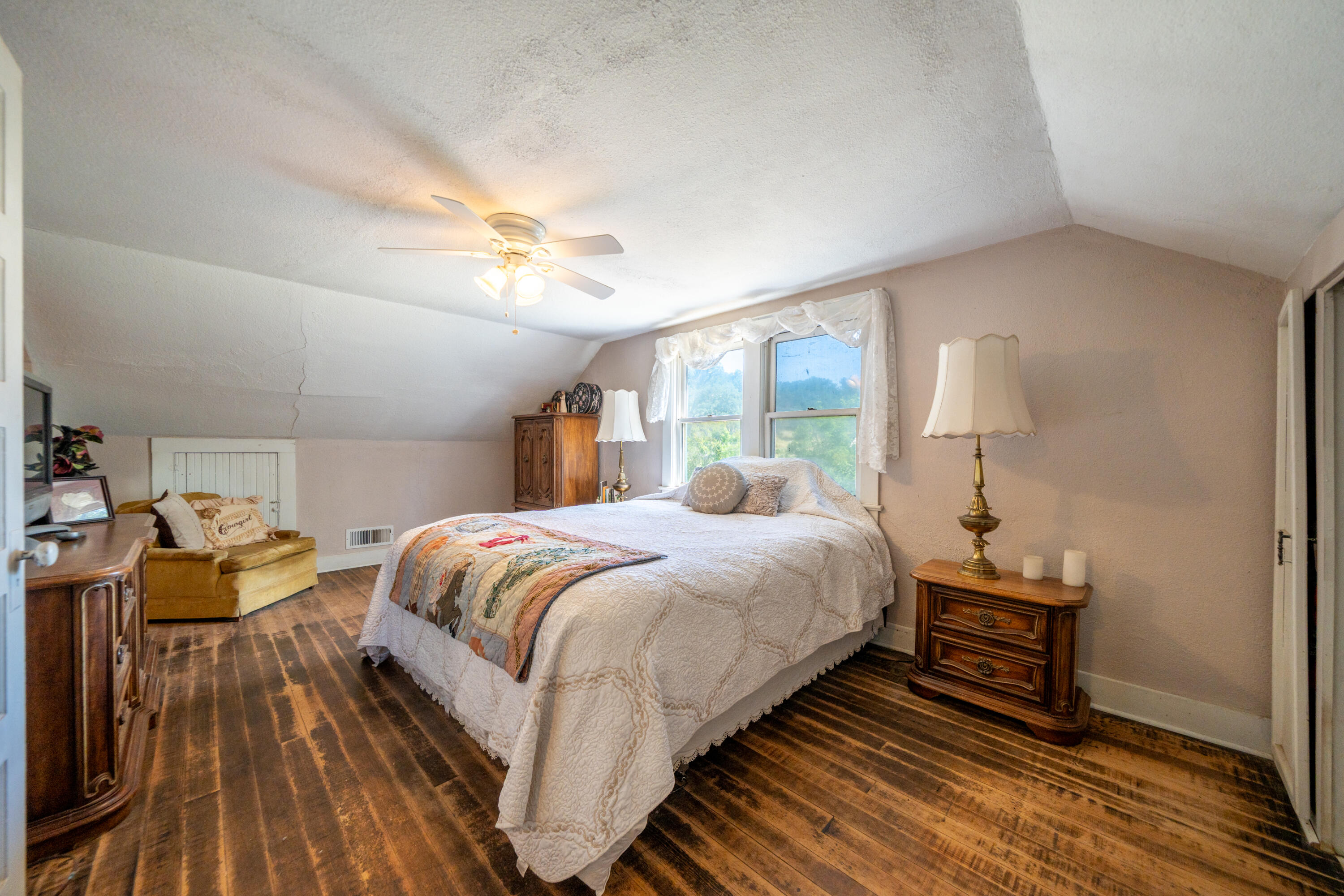 24294 Dersch Road Shingletown, CA 96088 - Photo 18 of 34 a bedroom with a bed and a chandelier