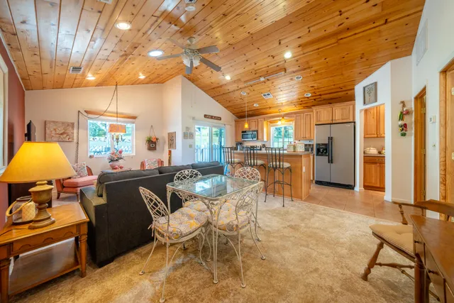 a living room with furniture and a dining table