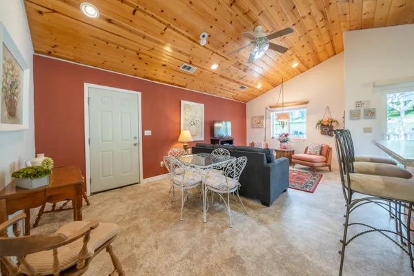 a living room with furniture and a dining table