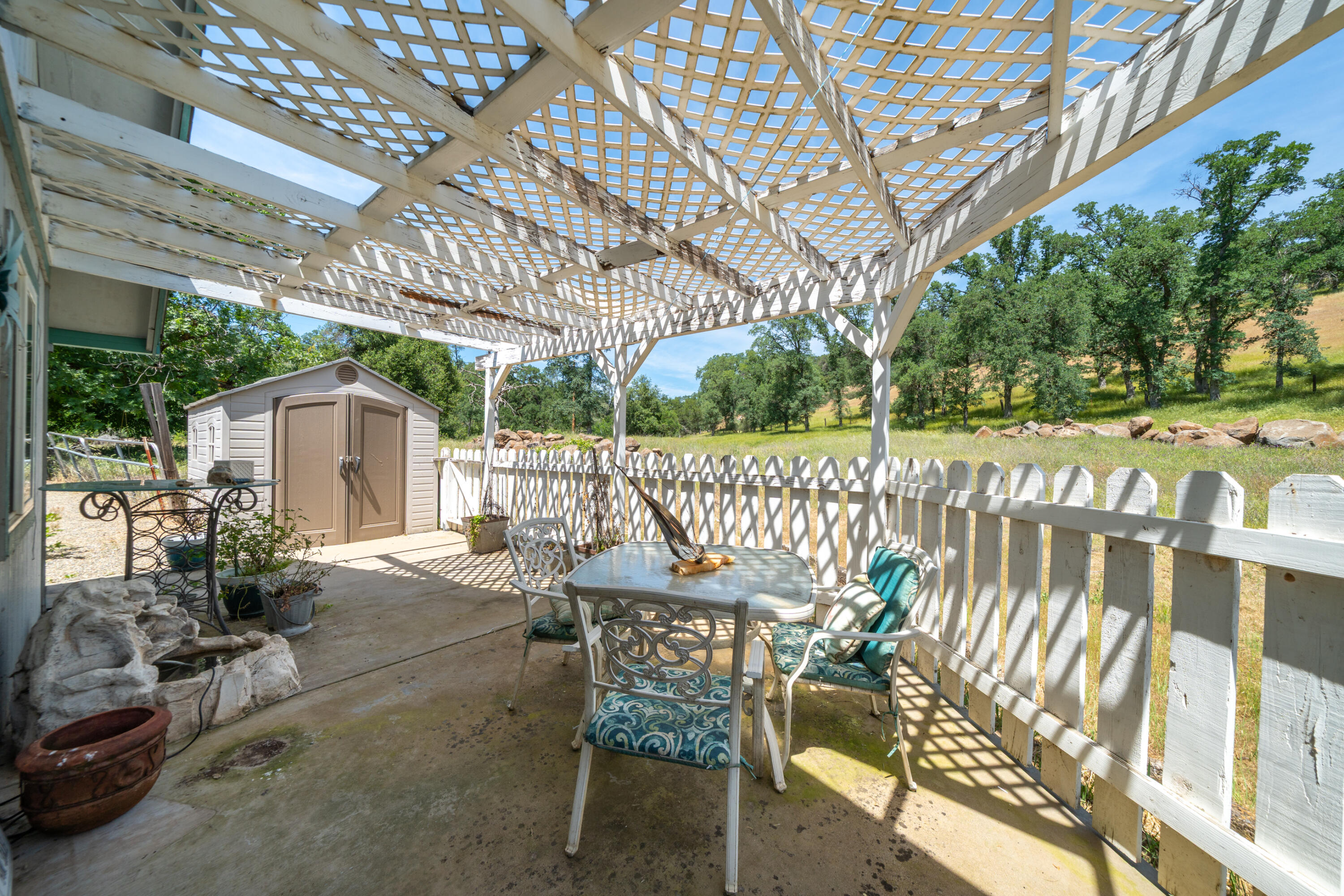 24294 Dersch Road Shingletown, CA 96088 - Photo 30 of 34 a view of a chair and tables in the patio next to a yard