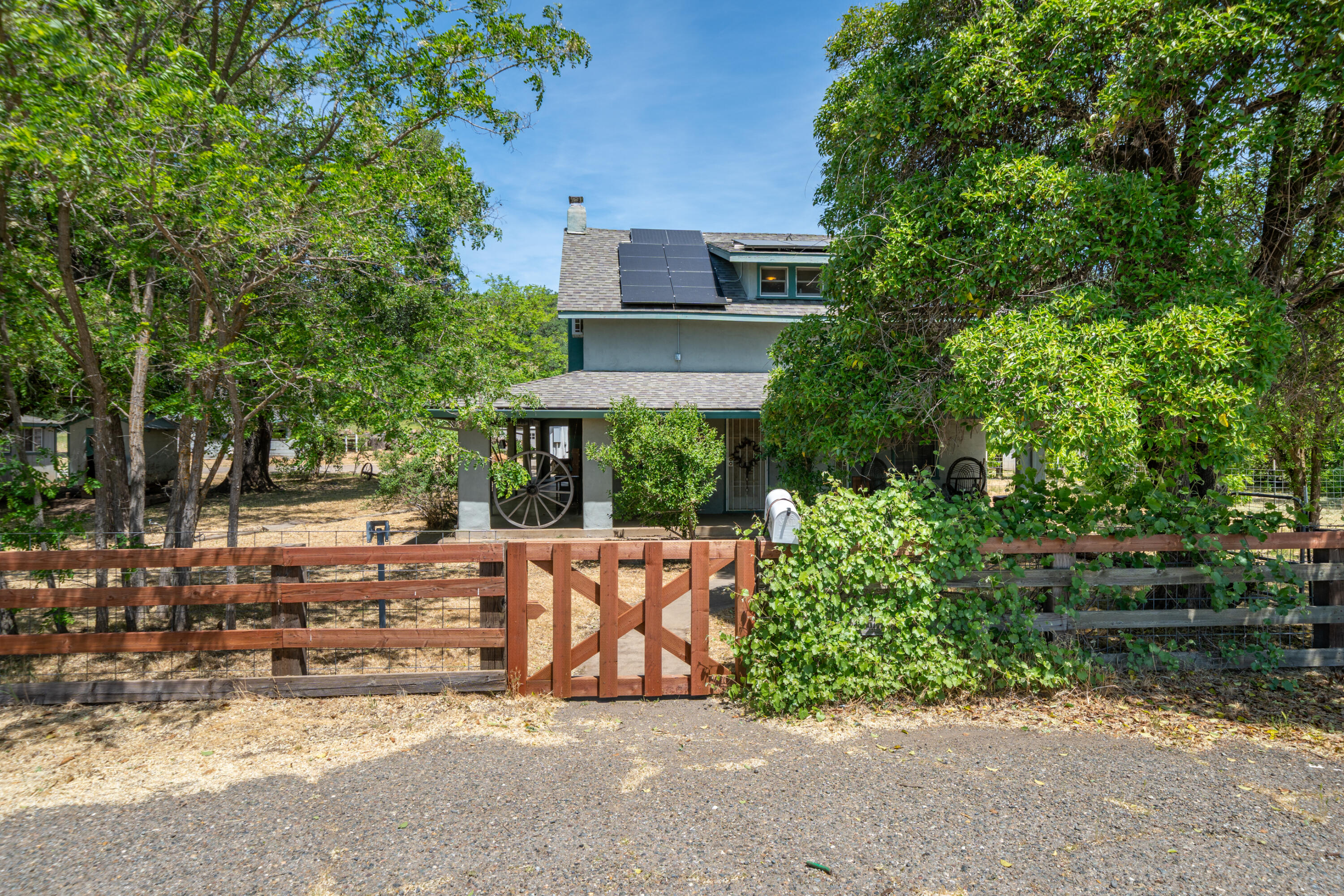 24294 Dersch Road Shingletown, CA 96088 - Photo 3 of 34 a view of a house with a garden and pathway