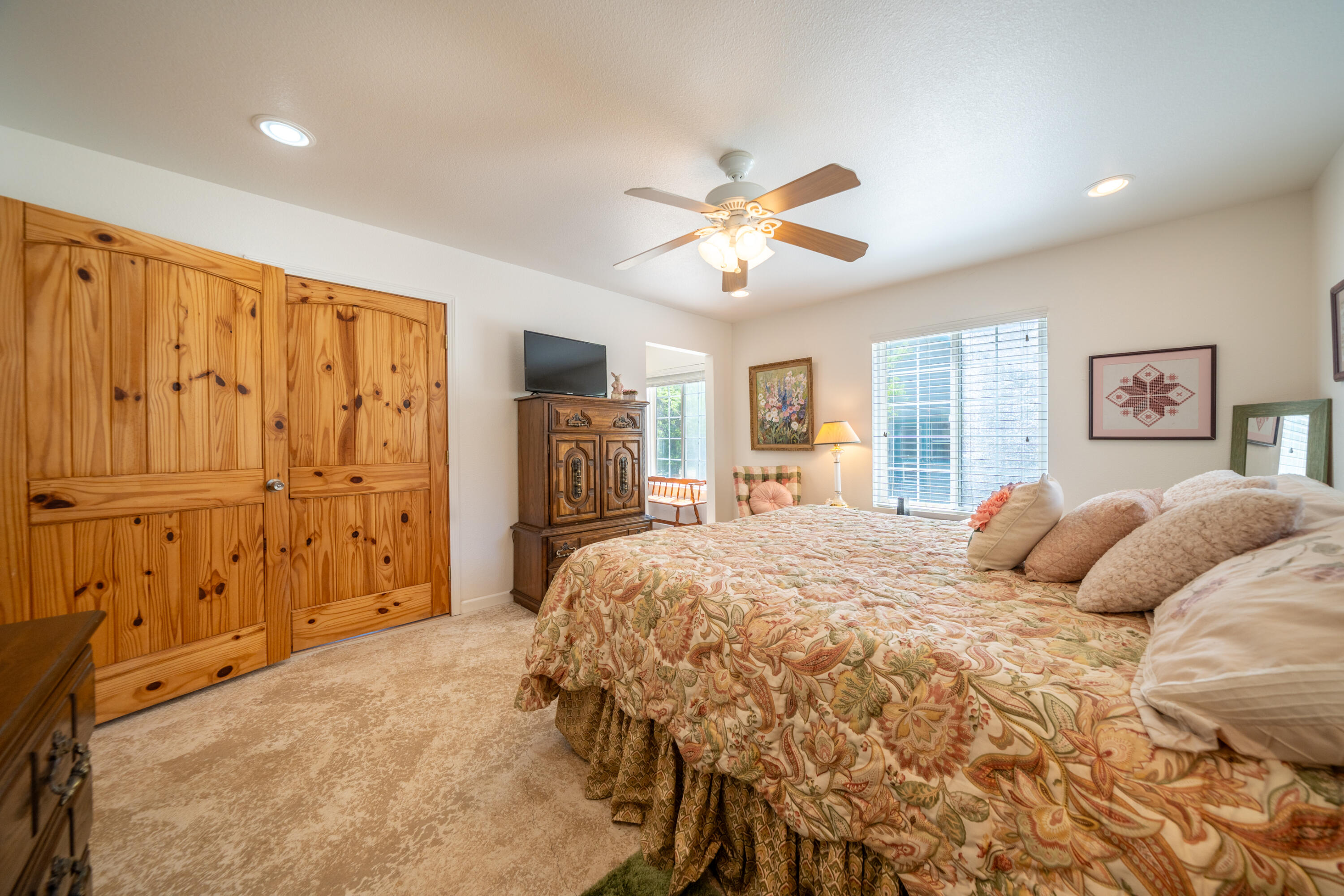 24294 Dersch Road Shingletown, CA 96088 - Photo 8 of 34 a bedroom with a large bed closet and flat tv screen
