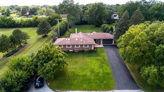 a aerial view of a house with a yard