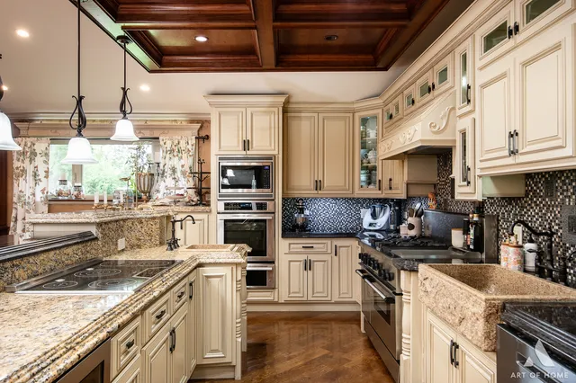 a kitchen with a stove sink and cabinets