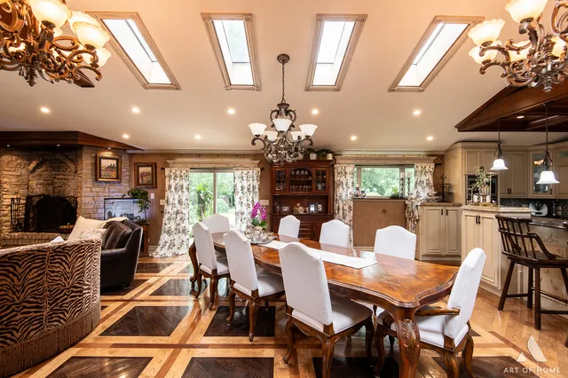 a view of a dining room with furniture a chandelier and wooden floor