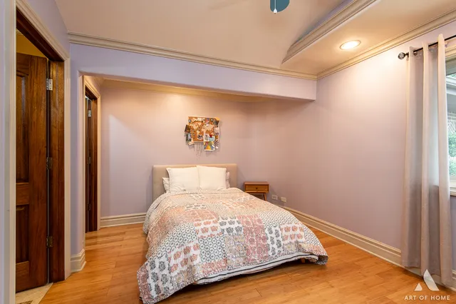 a bedroom with a bed and a painting on the wall