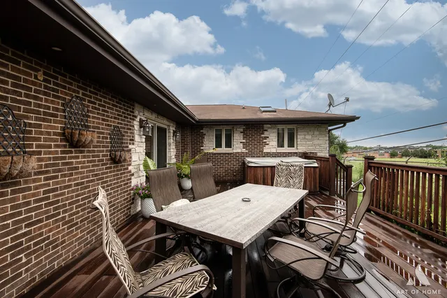 a view of a patio with table and chairs with wooden floor and fence