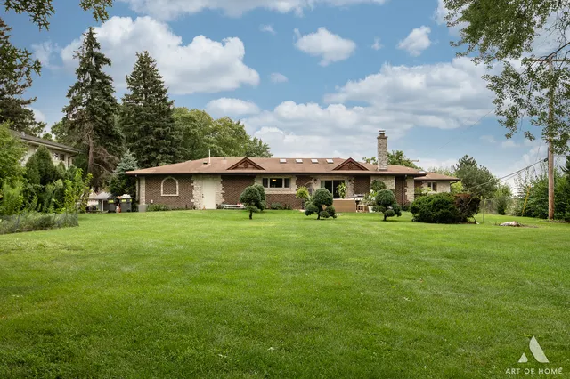 a front view of house with yard barbeque and outdoor seating