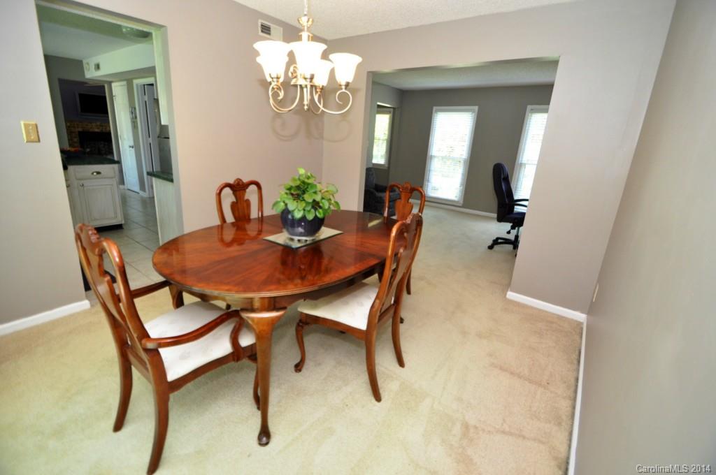 10336 Fairway Ridge Road Charlotte, NC 28277 - Photo 8 of 23 a view of a dining room with furniture and a chandelier