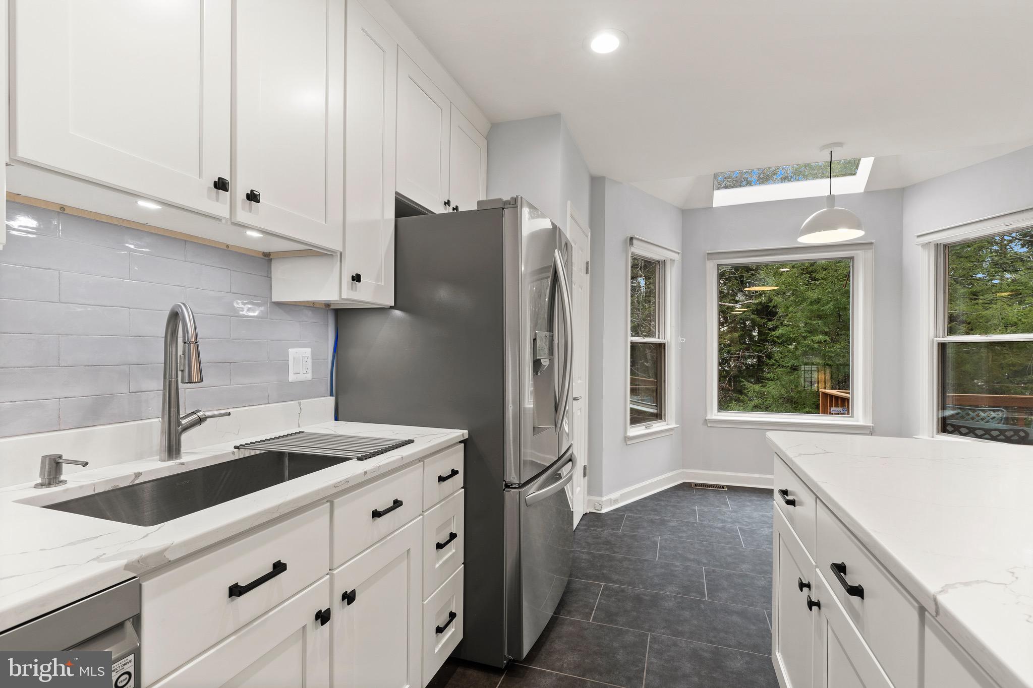 1474 Hampton Hill Circle McLean, VA 22101 - Photo 12 of 45 a kitchen with granite countertop a sink stainless steel appliances and cabinets