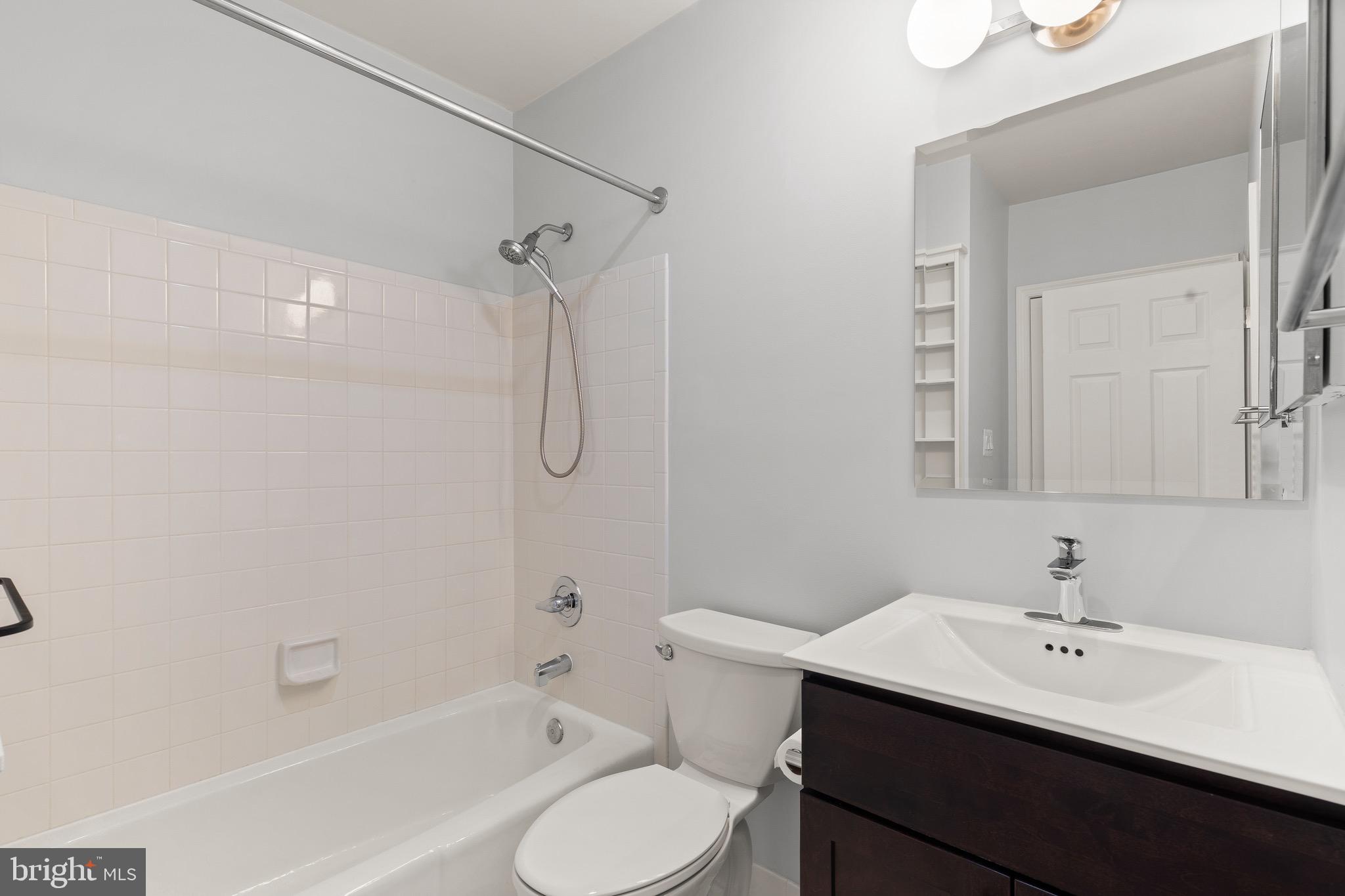 1474 Hampton Hill Circle McLean, VA 22101 - Photo 22 of 45 a bathroom with a sink toilet a mirror and shower