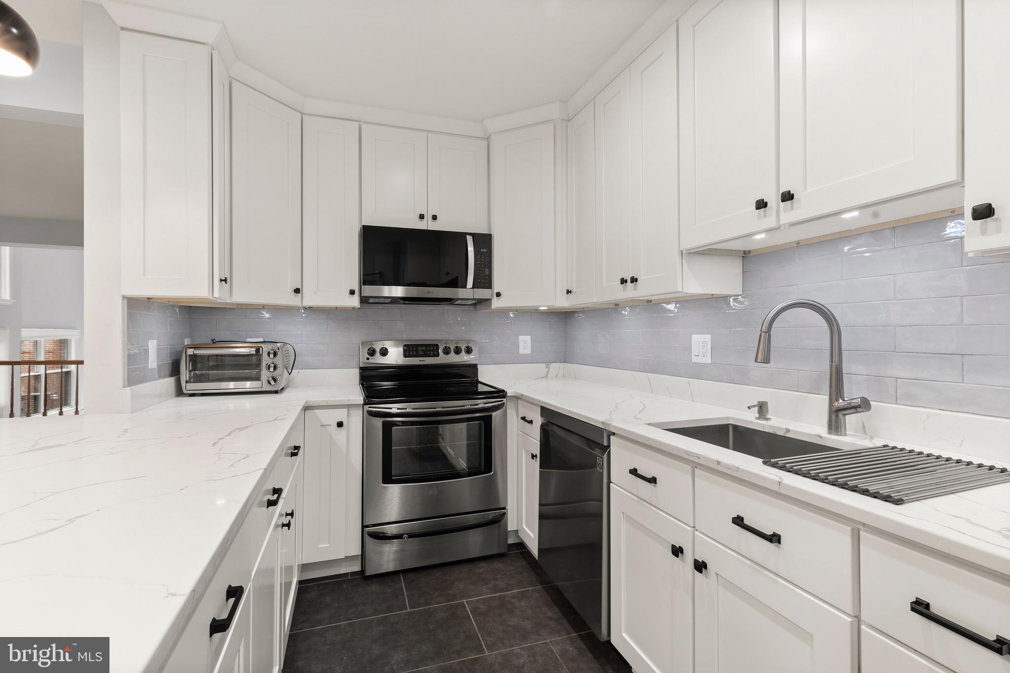 1474 Hampton Hill Circle McLean, VA 22101 - Photo 10 of 45 a kitchen with granite countertop white cabinets and stainless steel appliances