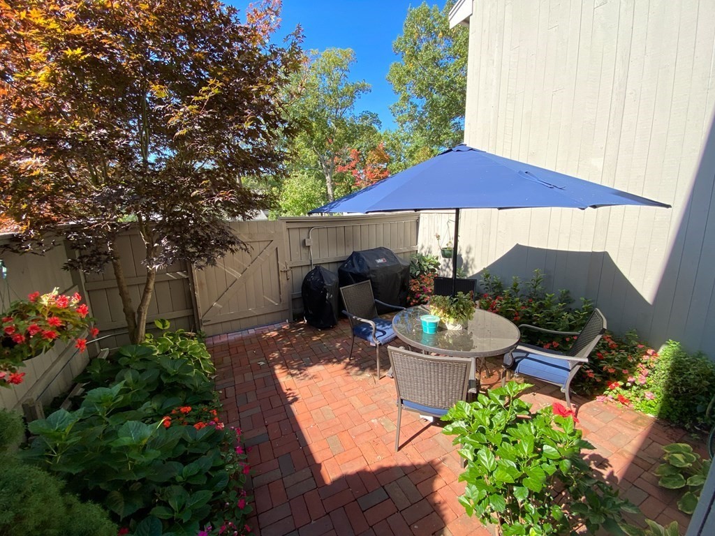 4 Mill Pond, Unit 4 North Andover, MA 01845 - Photo 4 of 6 a view of a patio with furniture and a garden