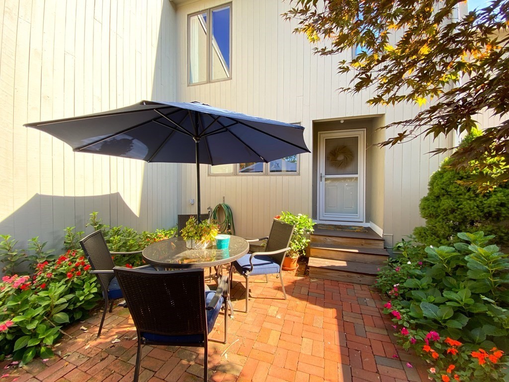 4 Mill Pond, Unit 4 North Andover, MA 01845 - Photo 6 of 6 a patio with a patio table and chairs