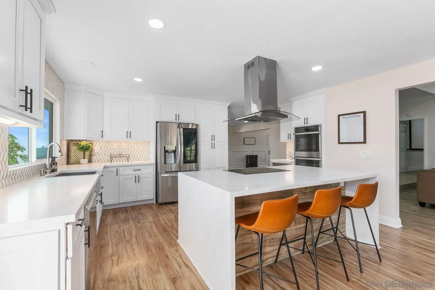 9431 West Lilac Road Escondido, CA 92026 - Photo 14 of 62 a large kitchen with stainless steel appliances granite countertop a table chairs sink and cabinets