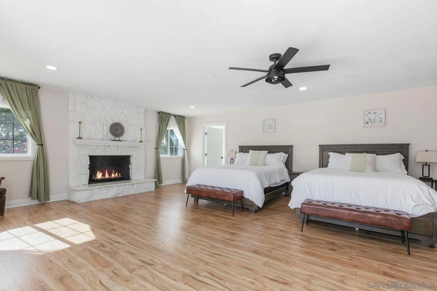 9431 West Lilac Road Escondido, CA 92026 - Photo 22 of 62 a bedroom with bed and a fireplace