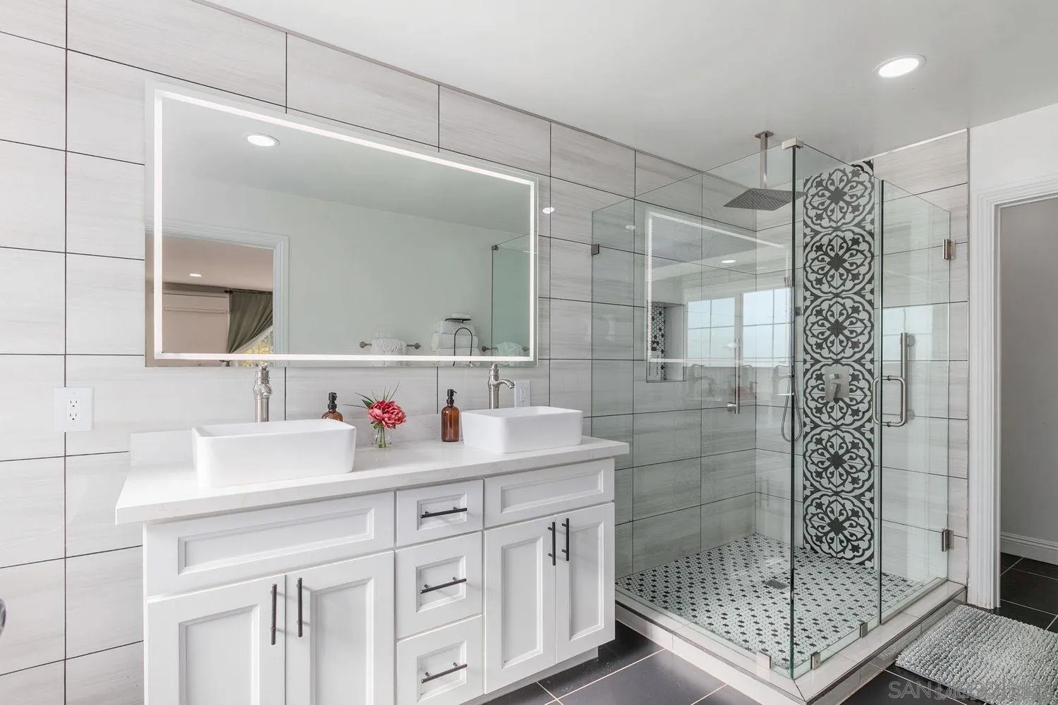 9431 West Lilac Road Escondido, CA 92026 - Photo 23 of 62 a bathroom with a shower sink and mirror