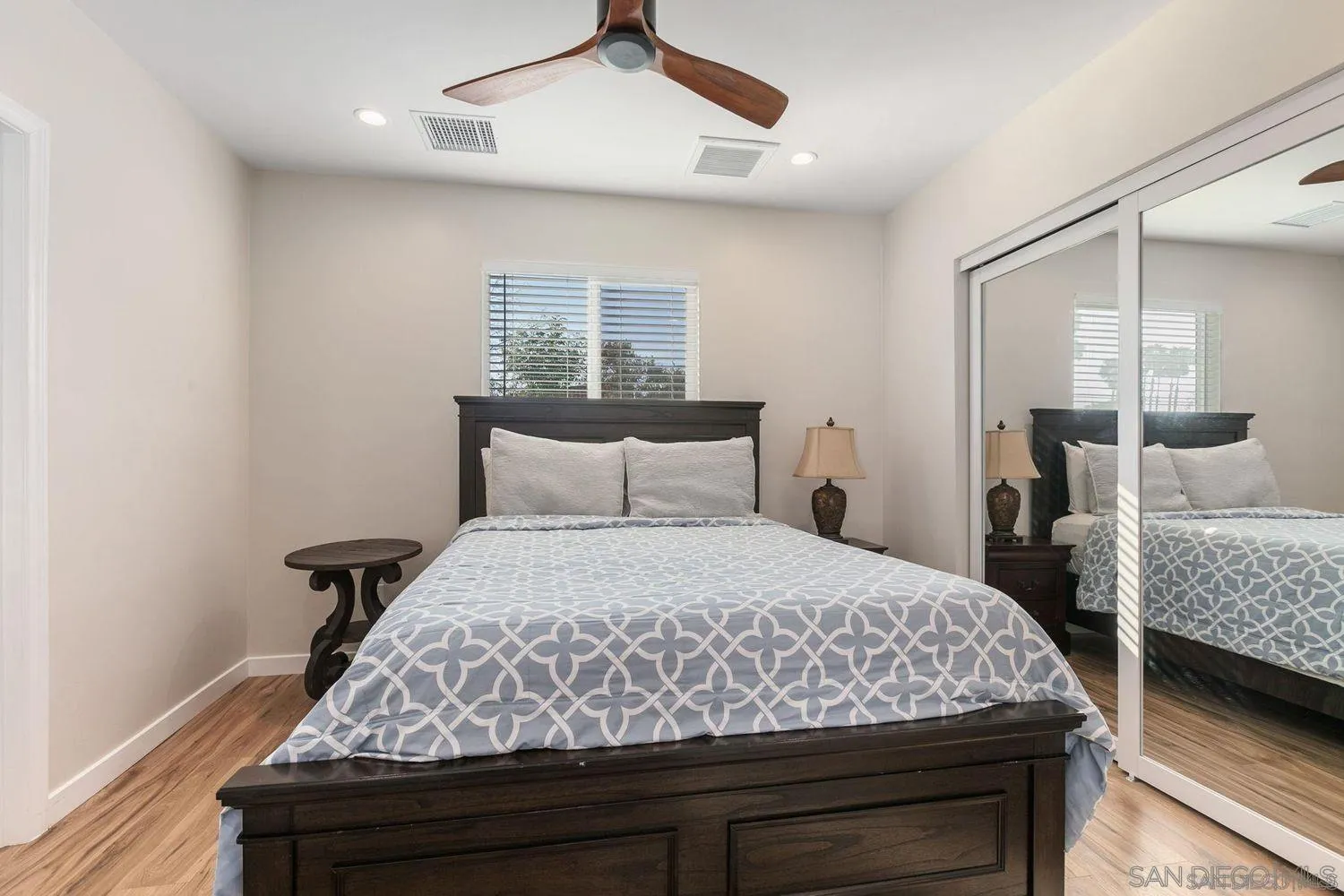 9431 West Lilac Road Escondido, CA 92026 - Photo 54 of 62 a bedroom with bed and wooden floor