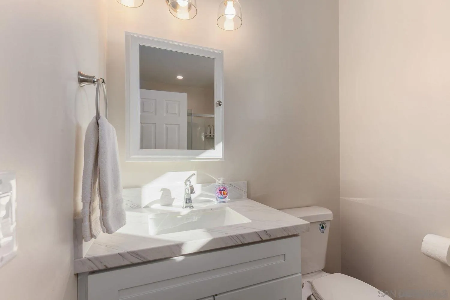 9431 West Lilac Road Escondido, CA 92026 - Photo 55 of 62 a bathroom with a sink toilet and mirror