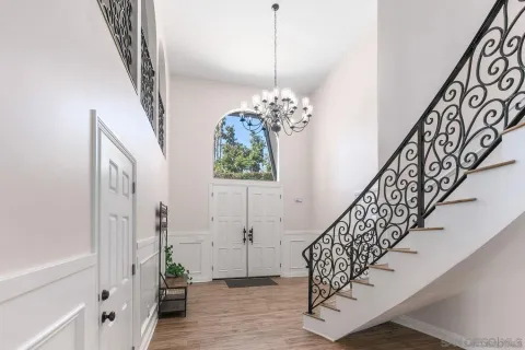 a view of entryway with stairs and wooden floor