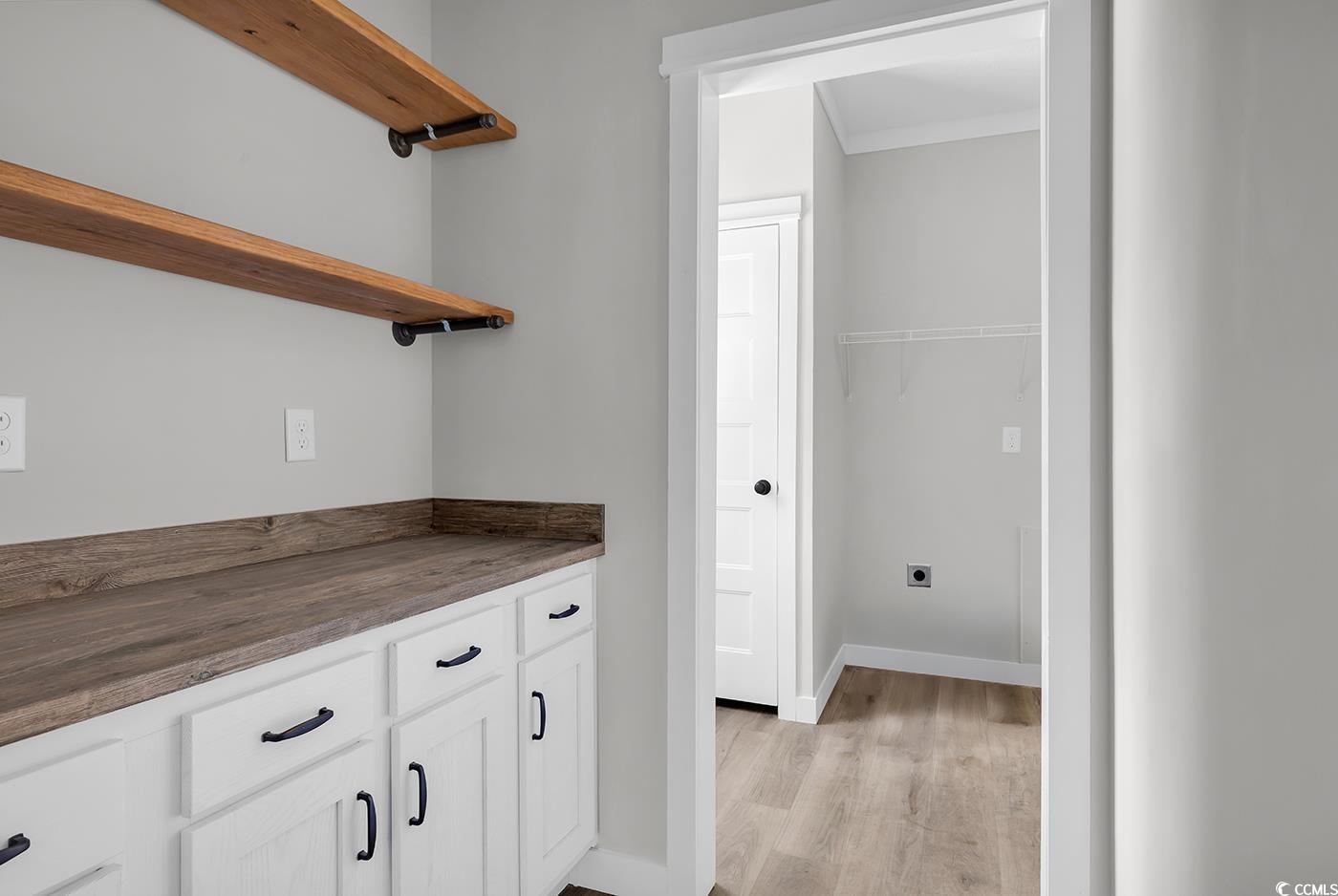 754 Kent Road Andrews, SC 29510 - Photo 11 of 31 Kitchen featuring stainless steel appliances, wall chimney range hood, a kitchen island, white cabinets, and coffered ceiling