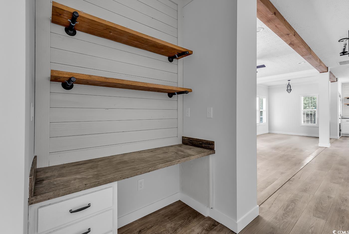 754 Kent Road Andrews, SC 29510 - Photo 15 of 31 Unfurnished dining area with beamed ceiling, healthy amount of natural light, light wood-type flooring, and a chandelier