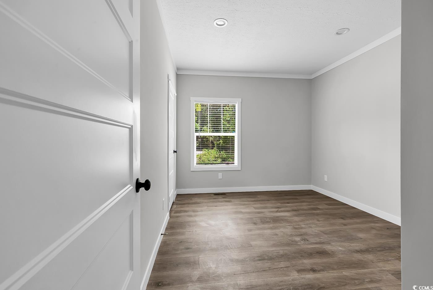 754 Kent Road Andrews, SC 29510 - Photo 19 of 31 Unfurnished bedroom with light wood finished floors and ornamental molding