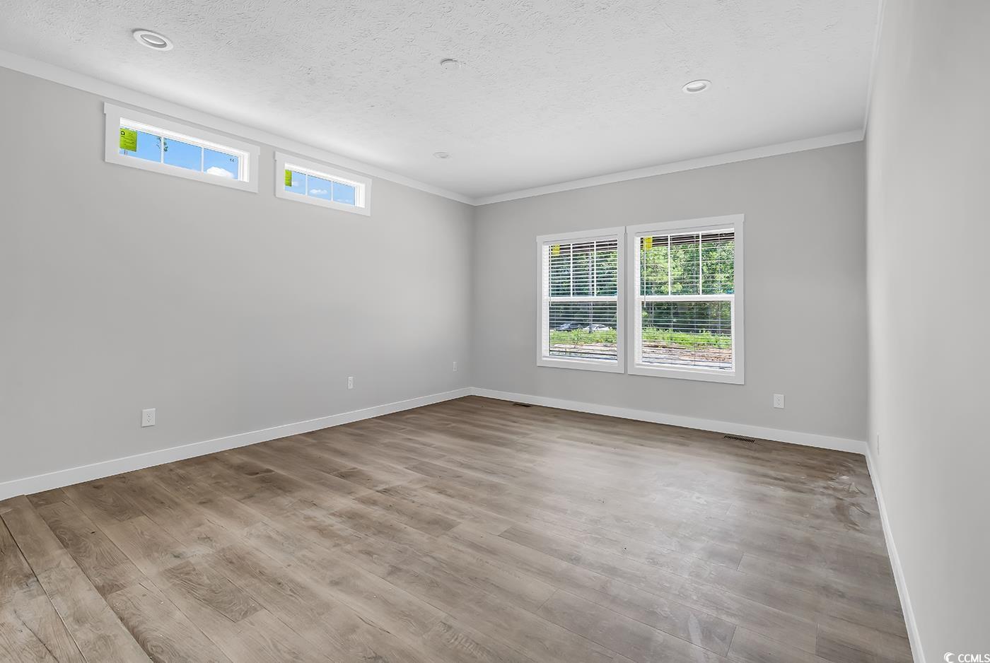754 Kent Road Andrews, SC 29510 - Photo 23 of 31 Full bathroom with a textured ceiling, shower / bath combination, dark wood-style flooring, vanity, and crown molding