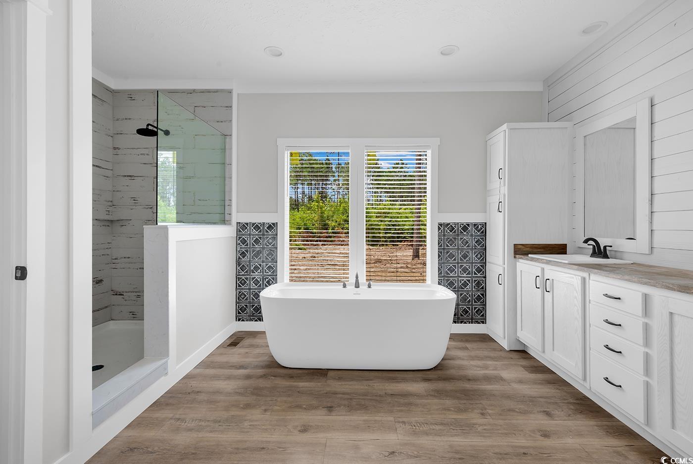 754 Kent Road Andrews, SC 29510 - Photo 27 of 31 Bathroom with wood finished floors and a freestanding bath